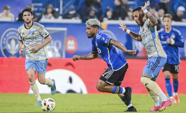 CF Montreal's Josef Martínez (17) breaks away from Philadelphia Union's Jesus Bueno (20) during the first half of an MLS soccer match Saturday, June 29, 2024, in Montreal. (Graham Hughes/The Canadian Press via AP)