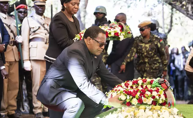 Malawian President Lazarus Chakwera, lays a wreath at the burial service for Malawi's Vice President Saulos Chilima in Nsipe, Malawi, Monday, June 17, 2024. (AP Photo/Thoko Chikondi)