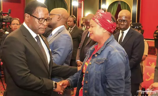 Malawian President Lazarus Chakwera, left, greets people in Lilongwe, Tuesday, June 11, 2024 where he made an announcement that the Vice President and nine others had been killed in a plane crash. The wreckage of the military plane carrying Vice President Saulos Chilima was located in a mountainous area in the north of the country after a search that lasted more than a day. (AP Photo)