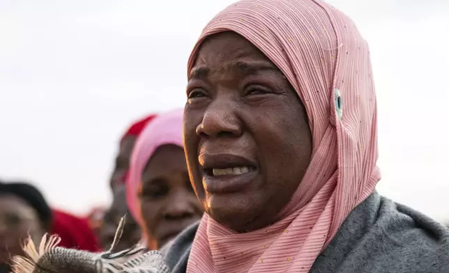 Mourners await the body of Vice President Saulos Chilima, at Kamuzu International Airport in Lilongwe, Malawi, Tuesday, June 11, 2024. The wreckage of the military plane carrying Vice President Chilima and nine others was located in a mountainous area in the north of the country after a search that lasted more than a day. (AP Photo/Thoko Chikondi)