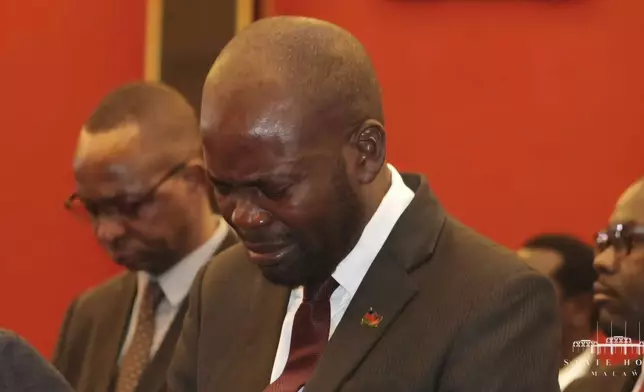 A man reacts to the Malawian President Lazarus Chakwera's news in Lilongwe, Tuesday, June 11, 2024 that the Vice President and nine others had been killed in a plane crash. The wreckage of the military plane carrying Vice President Saulos Chilima was located in a mountainous area in the north of the country after a search that lasted more than a day. (AP Photo)