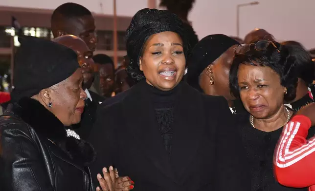 Wife of Vice President Saulos Chilima, Mary Chilima, centre, is comforted by Malawi First Lady Monica Chakwera, left, at Kamuzu International Airport in Lilongwe, Malawi, Tuesday, June 11, 2024 as they await the body of the vice president and nine others killed in a plane crash. The wreckage of the military plane carrying Vice President Chilima was located in a mountainous area in the north of the country after a search that lasted more than a day. (AP Photo/Thoko Chikondi)