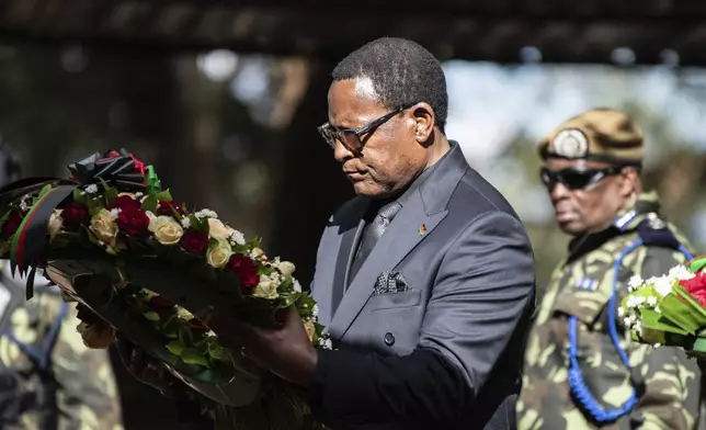 Malawian President Lazarus Chakwera, lays a wreath at the burial service for Malawi's Vice President Saulos Chilima in Nsipe, Malawi, Monday, June 17, 2024. (AP Photo/Thoko Chikondi)