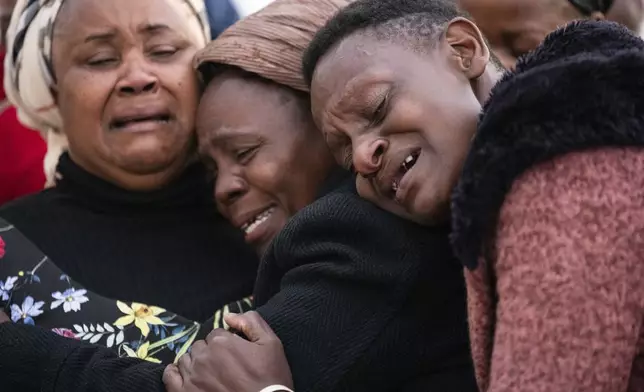 Mourners await the body of Vice President Saulos Chilima, at Kamuzu International Airport in Lilongwe, Malawi, Tuesday, June 11, 2024. The wreckage of the military plane carrying Vice President Chilima and nine others was located in a mountainous area in the north of the country after a search that lasted more than a day. (AP Photo/Thoko Chikondi)