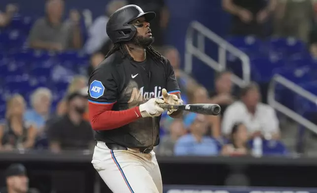 Miami Marlins' Josh Bell watches as he hits a home run to center field during the sixth inning of a baseball game against the Seattle Mariners, Friday, June 21, 2024, in Miami. (AP Photo/Marta Lavandier)