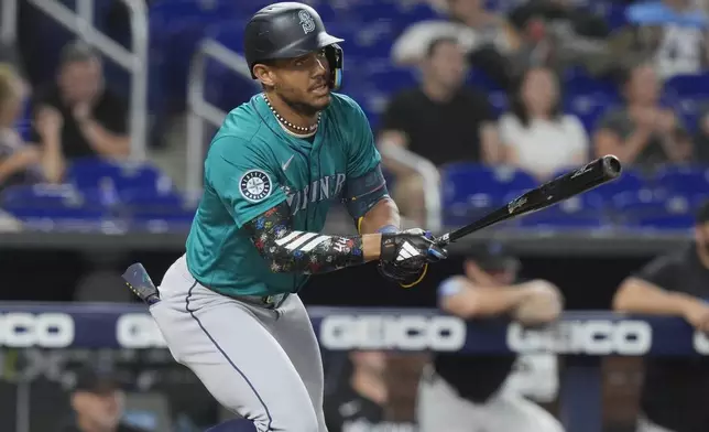 Seattle Mariners' Julio Rodríguez hits a single during the first inning of a baseball game against the Miami Marlins, Friday, June 21, 2024, in Miami. (AP Photo/Marta Lavandier)