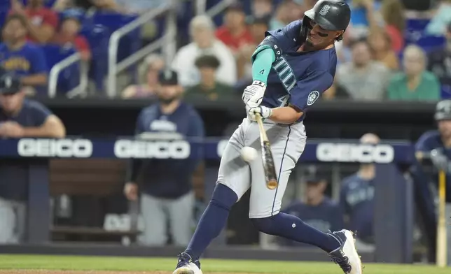 Seattle Mariners' Josh Rojas gets a base hit during the first inning of a baseball game against the Miami Marlins, Saturday, June 22, 2024, in Miami. (AP Photo/Wilfredo Lee)