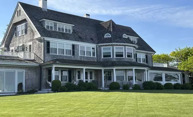 A home sits on a freshly mowed lawn in Edgartown, Mass., Tuesday, June 4, 2024. High housing costs on Martha's Vineyard are forcing many regular workers to leave and are threatening public safety. (AP Photo/Nick Perry)