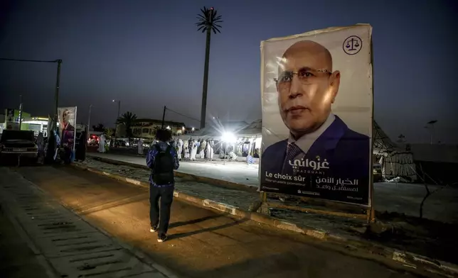 An electoral banner for Mauritanian president Mohamed Ould Ghazouani is placed during a campaign rally, ahead of the presidential elections in Nouakchott, Mauritania, Wednesday, June 26, 2024. Banner in Arabic reads: "Safe choice." (AP Photo/Mamsy Elkeihel)
