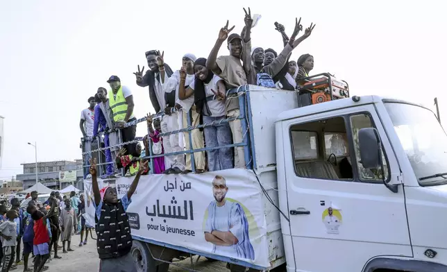 Youth take part in an electoral rally ahead of the upcoming presidential elections in Nouakchott, Mauritania, Tuesday, June 25, 2024. Banner in Arabic reads "For the youth." (AP Photo/Mamsy Elkeihel)