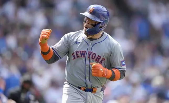 New York Mets' Francisco Alvarez reacts towards his teammates after hitting a home run off Chicago Cubs pitcher Jameson Taillon in the fifth inning of a baseball game Saturday, June 22, 2024, in Chicago. (AP Photo/Charles Rex Arbogast)