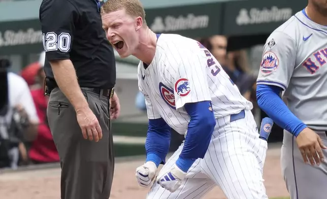 Chicago Cubs' Pete Crow-Armstrong reacts on third after hitting an RBI triple off New York Mets starting pitcher Tylor Megill in the first inning of a baseball game Saturday, June 22, 2024, in Chicago. (AP Photo/Charles Rex Arbogast)