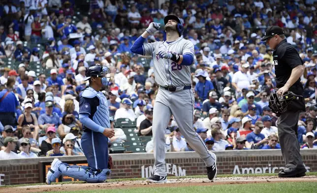 New York Mets designated hitter J.D. Martinez looks towards the sky as he crosses home plate after hitting a three-run home run in the first inning of a baseball game against the Chicago Cubs, Friday, June 21, 2024, in Chicago. (AP Photo/Matt Marton)