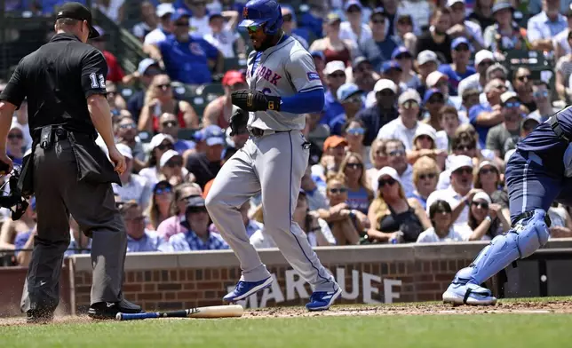 New York Mets' Starling Marte scores during the third inning of a baseball game against the Chicago Cubs, Friday, June 21, 2024, in Chicago. (AP Photo/Matt Marton)