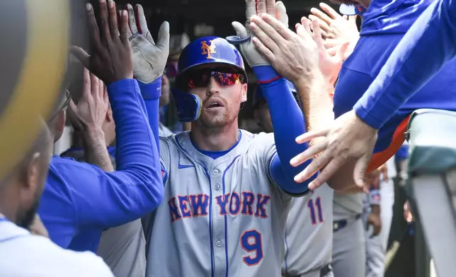 New York Mets' Brandon Nimmo celebrates in the dugout hitting a two-run home run in the second inning of a baseball game against the Chicago Cubs, Friday, June 21, 2024, in Chicago. (AP Photo/Matt Marton)