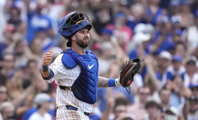 Chicago Cubs catcher Tomás Nido begins to celebrate a win over the New York Mets in a baseball game Saturday, June 22, 2024, in Chicago. (AP Photo/Charles Rex Arbogast)