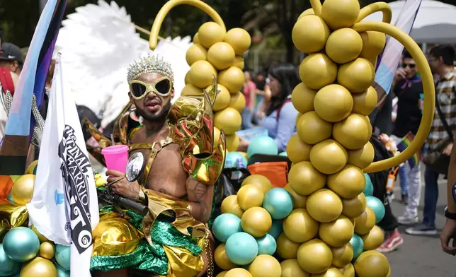 A participant strikes a pose during the annual Gay Pride parade marking the culmination of LGBTQ+ Pride month, in Mexico City, Saturday, June 29, 2024. (AP Photo/Aurea Del Rosario)