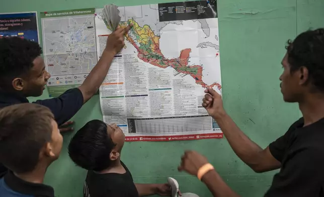 Teenager migrants look at a map of Mexico at the Peace Oasis of the Holy Spirit Amparito shelter in Villahermosa, Mexico, on Friday, June 7, 2024. After the head of Mexico's immigration agency ordered a halt to deportations in December, migrants have been left in limbo as authorities round up migrants across the country and dump them in the southern Mexican cities of Villahermosa and Tapachula. (AP Photo/Felix Marquez)