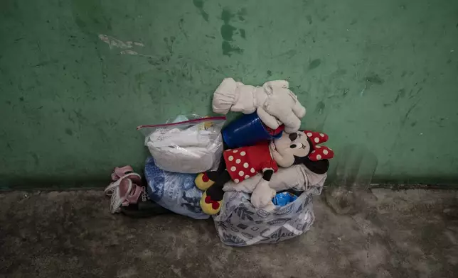 A Venezuelan migrant girl's belongings lay on the floor at the Peace Oasis of the Holy Spirit Amparito shelter in Villahermosa, Mexico, Friday, June 7, 2024. After the head of Mexico's immigration agency ordered a halt to deportations in December, migrants have been left in limbo as authorities round up migrants across the country and dump them in the southern Mexican cities of Villahermosa and Tapachula. (AP Photo/Felix Marquez)