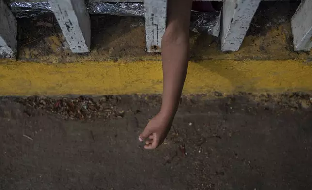 The Bolaños sisters, from Venezuela, sleep on the ground outside the bus terminal where they are living with their single mother Keilly and one other sibling, along with other migrants in Villahermosa, Mexico, Saturday, June 8, 2024. Their mother said that in Mexico's northern state of Juarez she was beaten by the military in front of her children, loaded on a bus for two days, and left in Villahermosa. (AP Photo/Felix Marquez)