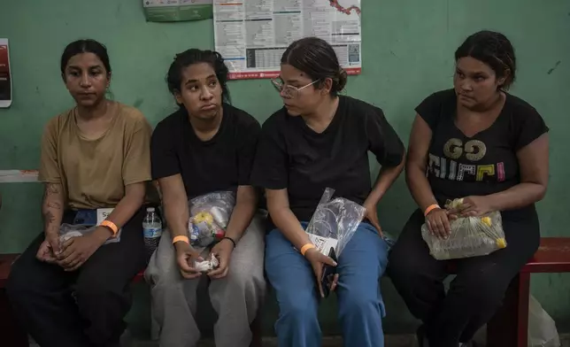 Venezuelan migrant Yeneska Garcia, second from left, sits with other migrants at the Peace Oasis of the Holy Spirit Amparito shelter in Villahermosa, Mexico, Friday, June 7, 2024. "I would rather cross the Darien Gap 10,000 times than cross Mexico once," Garcia said. (AP Photo/Felix Marquez)