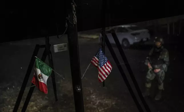 Mexican and U.S. flags decorate the window of a passenger bus that serves southern Mexico that stopped at an immigration checkpoint for inspection in Nuevo Teapa, southern Mexico, Saturday, June 8, 2024. Mexico is under pressure from the U.S. to block millions of migrants headed north. (AP Photo/Felix Marquez)