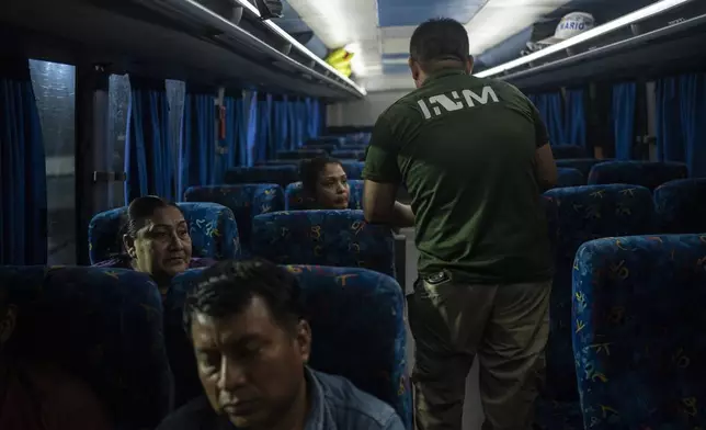 A National Migration Institute agent checks the documents of bus passengers at an immigration checkpoint in Nuevo Teapa, southern Mexico, Saturday, June 8, 2024. Mexico is under pressure from the U.S. to block millions of migrants headed north. (AP Photo/Felix Marquez)