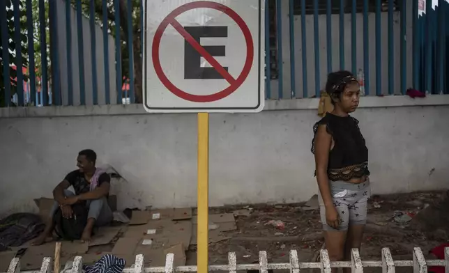 Venezuelan migrant Keilly Bolaños stands outside the bus terminal where she is living with her children and other migrants in Villahermosa, Mexico, Saturday, June 8, 2024. The single mother and her four children have been returned back to southern Mexico six times. (AP Photo/Felix Marquez)