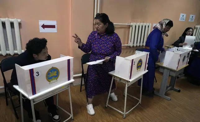 Voters prepare their votes at a polling station in the Ger District on the outskirts of Ulaanbaatar, Mongolia, Friday, June 28, 2024. Voters in Mongolia are electing a new parliament on Friday in their landlocked democracy that is squeezed between China and Russia, two much larger authoritarian states. (AP Photo/Ng Han Guan)