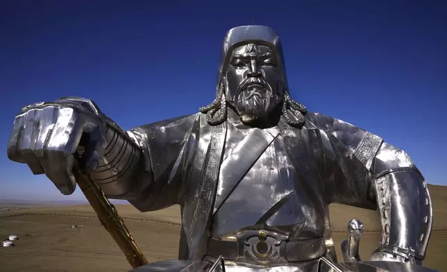 A 40-meter (130 feet) tall, stainless steel statue of Genghis Khan on horseback stands on top of a museum, 54 km (33.55 miles) east of the Mongolian capital Ulaanbaatar, Friday, May 12, 2023. Since Mongolia gained full autonomy and transitioned to democracy, Genghis Khan has served as a cornerstone of the country's efforts to reclaim its national heritage. His likeness is everywhere, from bottles of vodka to the statue outside Ulaanbaatar. (AP Photo/Manish Swarup)