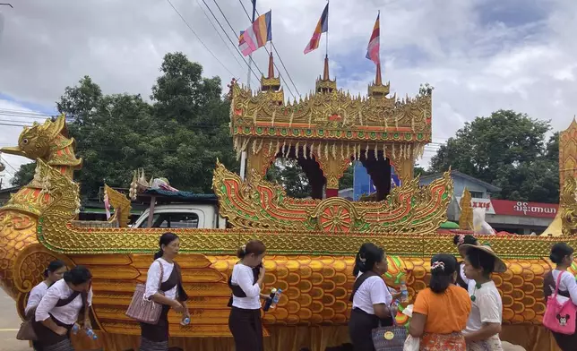 A vehicle with an elaborate design as a traditional Karaweik vessel carries the late monk Bhaddanta Munindarbhivamsa in a funeral cortege to be cremated in Bago, Myanmar, Thursday, June 27, 2024. The senior monk was shot dead last week by soldiers who the military government said mistaked the vehicle in which he was traveling for a security threat. (AP Photo)