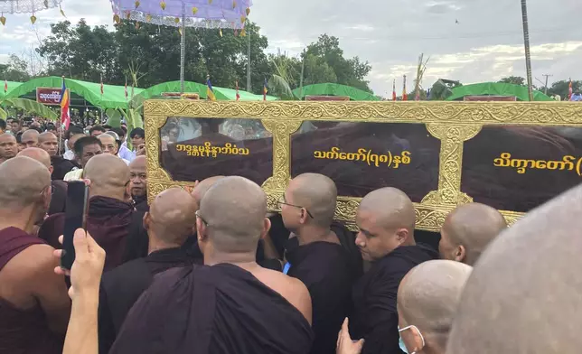 Buddhist monks carry the coffin of the late monk Bhaddanta Munindarbhivamsa before the cremation in Bago, Myanmar, Thursday, June 27, 2024. The senior monk was shot dead last week by soldiers who the military government said mistaked the vehicle in which he was traveling for a security threat. (AP Photo)