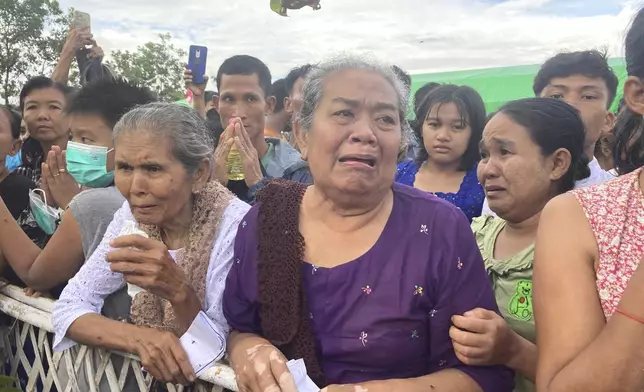 Mourners cry during the cremation ceremony for the late monk Bhaddanta Munindarbhivamsa in Bago, Myanmar, Thursday, June 27, 2024. The senior monk was shot dead last week by soldiers who the military government said mistaked the vehicle in which he was traveling for a security threat. (AP Photo)