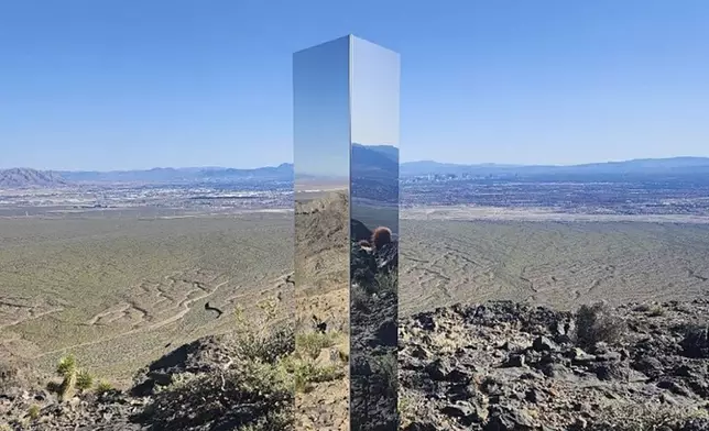 This photo provided by Las Vegas Metropolitan Police Department shows a monolith near Gass Peak, Nev., on Sunday, June 16, 2024. Jutting out of the rocks on a remote mountain peak near Las Vegas, the glimmering rectangular prism's reflective surface imitates the vast desert landscape surrounding the mountain peak where it has been erected. (Las Vegas Metropolitan Police Department via AP)