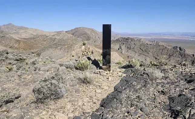 This photo provided by Las Vegas Metropolitan Police Department shows a monolith near Gass Peak, Nevada on Sunday, June 16, 2024. Jutting out of the rocks on a remote mountain peak near Las Vegas, the glimmering rectangular prism's reflective surface imitates the vast desert landscape surrounding the mountain peak where it has been erected. (Las Vegas Metropolitan Police Department via AP)