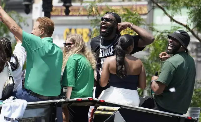 Boston Celtics NBA basketball championship MVP Jaylen Brown, center, celebrates during a duck boat parade Friday, June 21, 2024, in Boston. (AP Photo/Michael Dwyer)