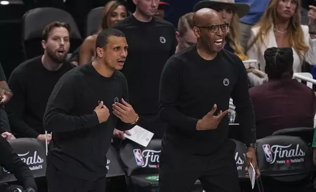 Boston Celtics head coach Joe Mazzulla, left, and assistant coach Sam Cassell react during the first half in Game 3 of the NBA basketball finals against the Dallas Mavericks, Wednesday, June 12, 2024, in Dallas. (AP Photo/Tony Gutierrez)