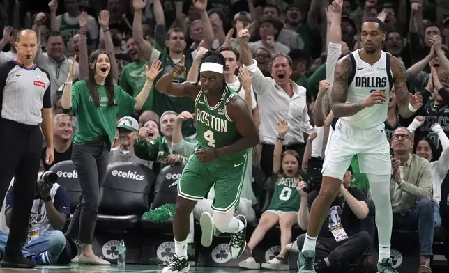 Boston Celtics guard Jrue Holiday (4) celebrates after scoring during the second half of Game 5 of the NBA basketball finals against the Dallas Mavericks, Monday, June 17, 2024, in Boston. (AP Photo/Charles Krupa)