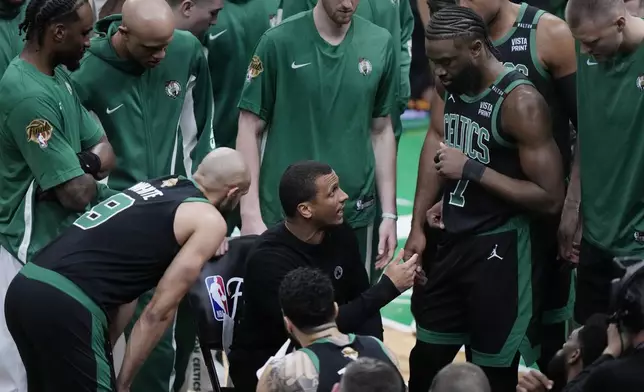 Boston Celtics head coach Joe Mazzulla, center, talks with his players during the first half of Game 2 of the NBA Finals basketball series against the Dallas Mavericks, Sunday, June 9, 2024, in Boston. (AP Photo/Steven Senne)