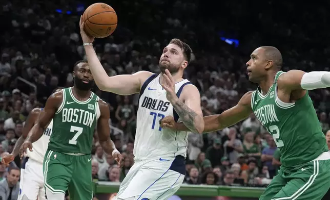 Dallas Mavericks guard Luka Doncic (77) drives as Boston Celtics guard Jaylen Brown (7) and center Al Horford, right, defend during the second half of Game 5 of basketball's NBA Finals, Monday, June 17, 2024, in Boston. (AP Photo/Charles Krupa)