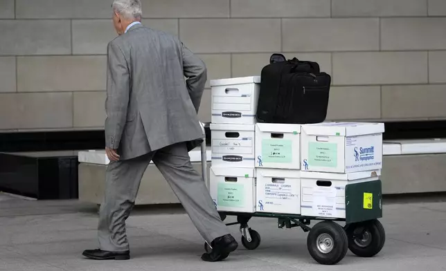 Case documents are wheeled into federal court Monday, June 17, 2024, in Los Angeles. NFL Commissioner Roger Goodell and Dallas Cowboys owner Jerry Jones, a longtime member of the league's broadcast committee, are expected to testify in a trial that could last up to three weeks. (AP Photo/Damian Dovarganes)