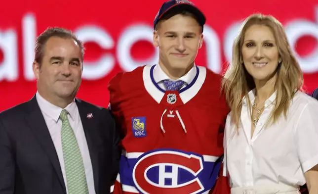 Ivan Demidov, center, poses, after being selected by the Montreal Canadiens during the first round of the NHL hockey draft Friday, June 28, 2024, in Las Vegas. The announcement was made by singer Celine Dion, right. (AP Photo/Steve Marcus)