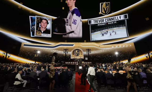 Trevor Connelly heads to the stage after being selected by the Vegas Golden Knights during the first round of the NHL hockey draft Friday, June 28, 2024, in Las Vegas. (AP Photo/Steve Marcus)