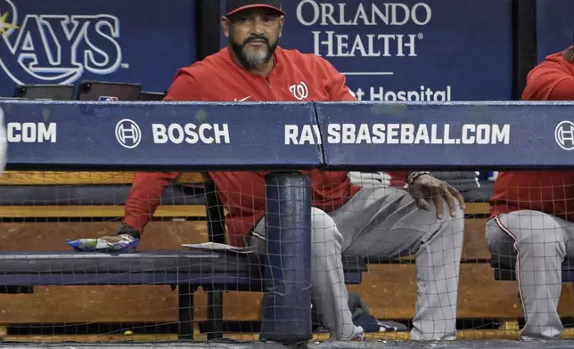 Washington Nationals manager Dave Martinez watches from the dugout during the third inning of the team's baseball game against the Tampa Bay Rays on Friday, June 28, 2024, in St. Petersburg, Fla. (AP Photo/Steve Nesius)
