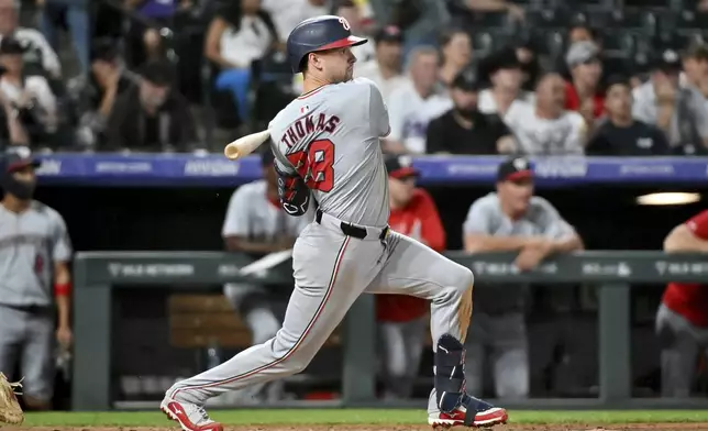 Washington Nationals' Lane Thomas watches his RBI single against the Colorado Rockies during the seventh inning of a baseball game Saturday, June 22, 2024, in Denver. (AP Photo/Geneva Heffernan)