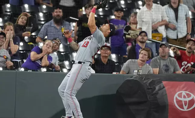 Washington Nationals third baseman Nick Senzel pulls in a pop foul by Colorado Rockies' Ryan McMahon to end the baseball game Friday, June 21, 2024, in Denver. (AP Photo/David Zalubowski)