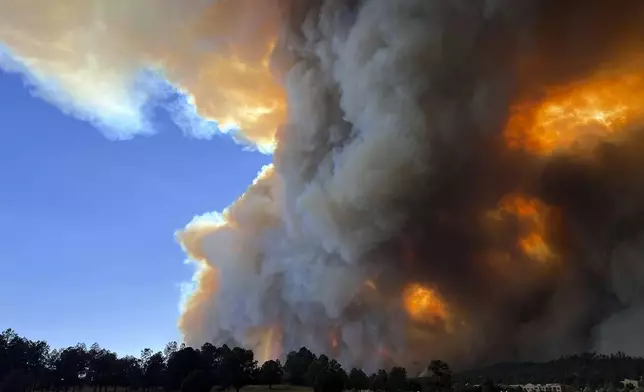 In this photo provided by Pam Bonner, smoke rises from fires in Ruidoso, N.M., Monday, June 17, 2024. Thousands of southern New Mexico residents fled the mountainous village as a wind-whipped wildfire tore through homes and other buildings. (Pam Bonner via AP)