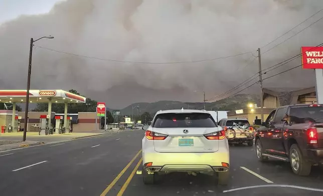 In this photo provided by Belinda Bukovitz, smoke rises from fires in Ruidoso, N.M., Monday, June 17, 2024. Thousands of southern New Mexico residents fled the mountainous village as a wind-whipped wildfire tore through homes and other buildings. (Belinda Bukovitz via AP)