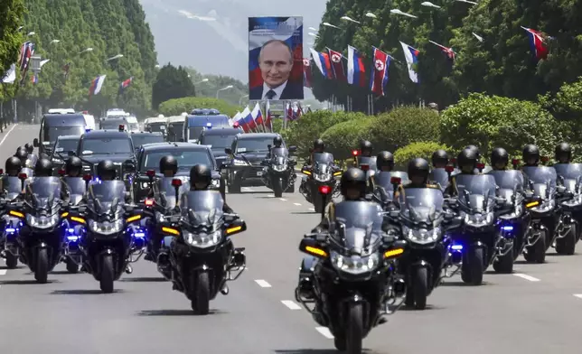 A motorcade with Russian President Vladimir Putin drives along a street in Pyongyang, North Korea, on Wednesday, June 19, 2024. (Gavriil Grigorov, Sputnik, Kremlin Pool Photo via AP)