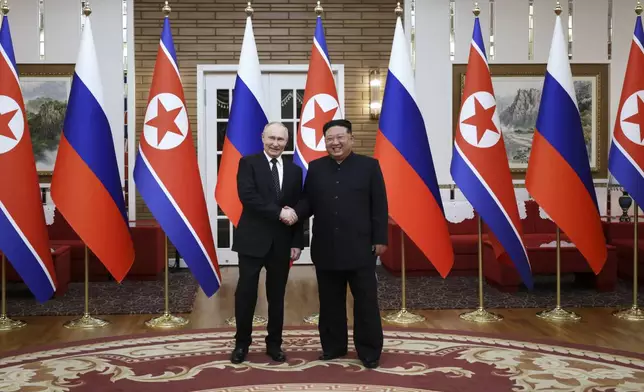 Russian President Vladimir Putin, left, and North Korea's leader Kim Jong Un pose for a photo after the official welcome ceremony in Pyongyang, North Korea, on Wednesday, June 19, 2024. (Gavriil Grigorov, Sputnik, Kremlin Pool Photo via AP)